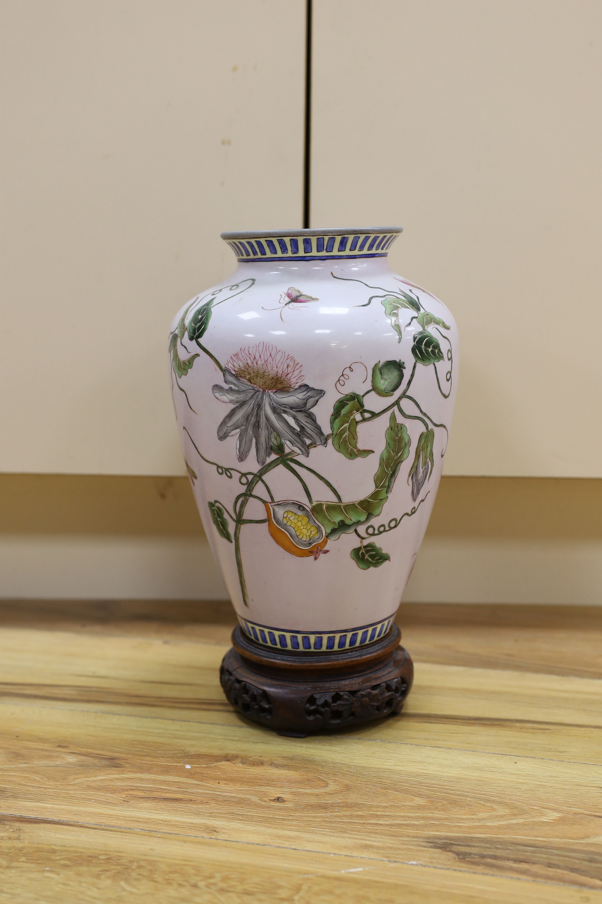 A Chinese famille noire table lamp and a pink ground Chinese vase, both on wooden stands, tallest vase 39cm